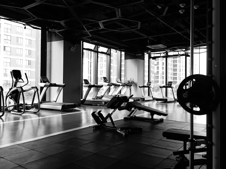 Cardio machines and benches in a high-rise building amenity gym